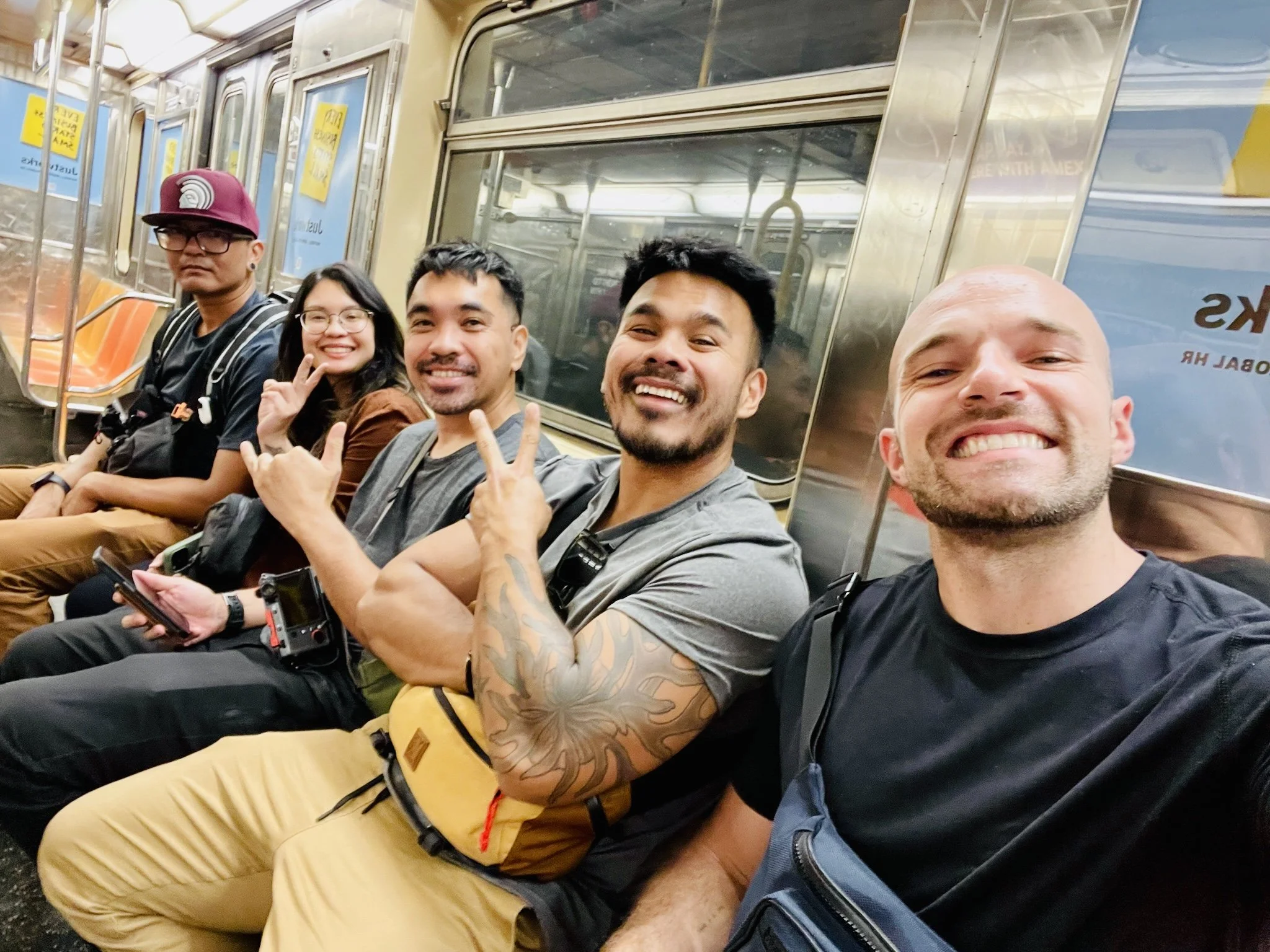 Five friends taking a selfie on a New York City subway train