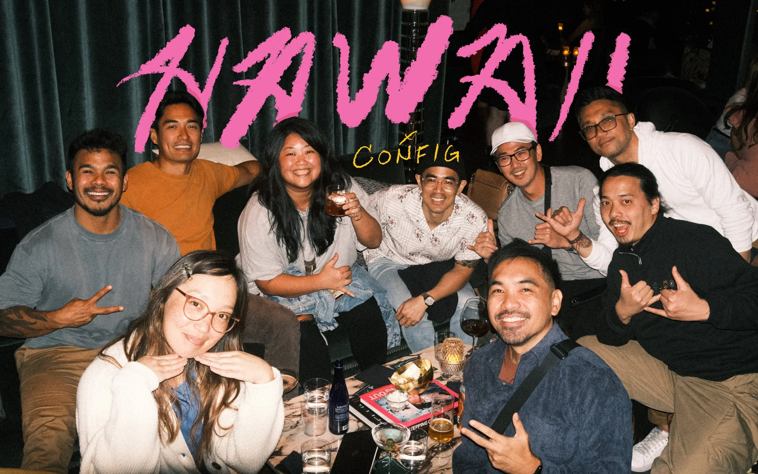 Nine Hawaii designers throwing shakas around a lounge table under handwritten Hawaii Config lettering