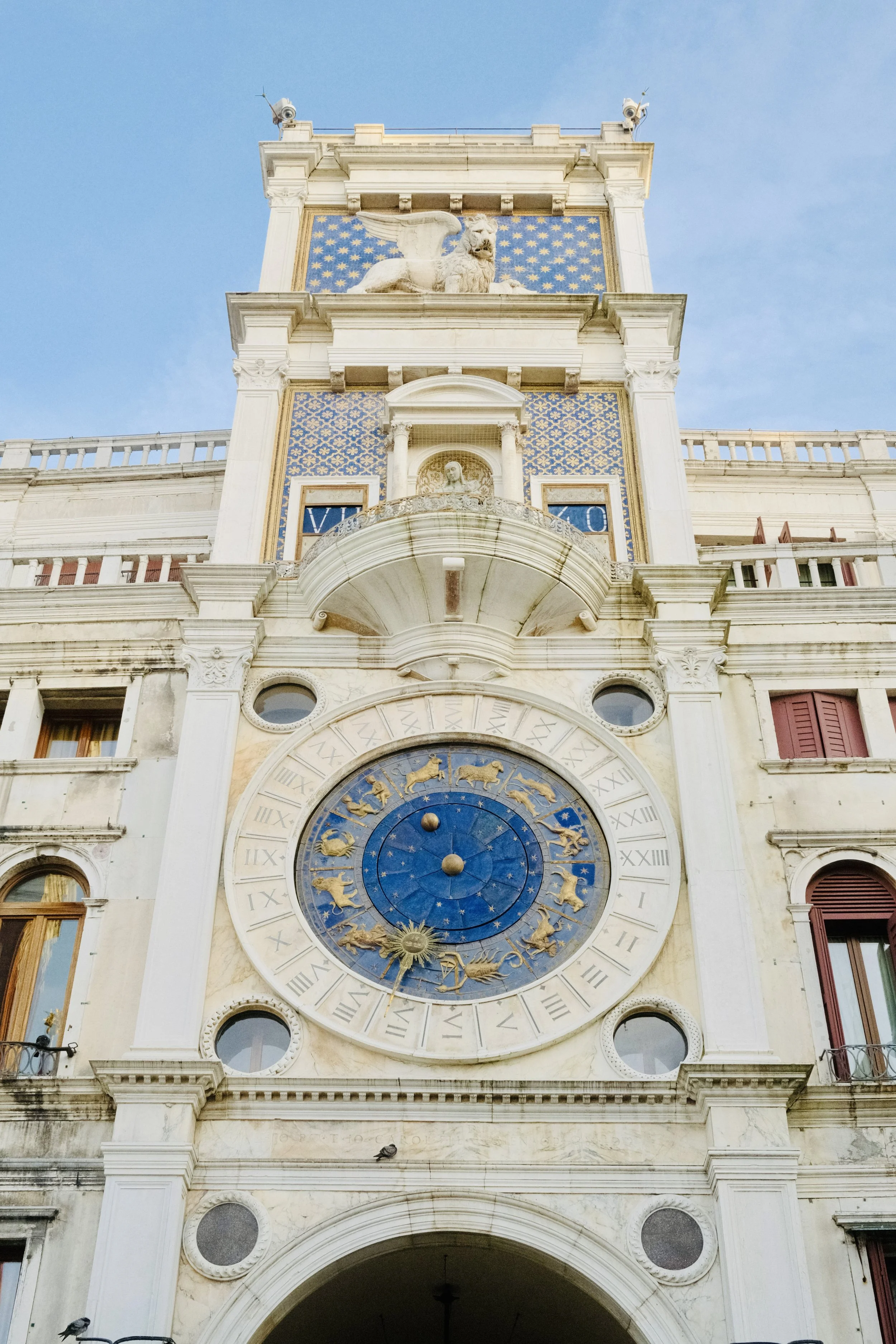 St Mark's Clock Tower in Venice with its blue zodiac clock face and winged lion