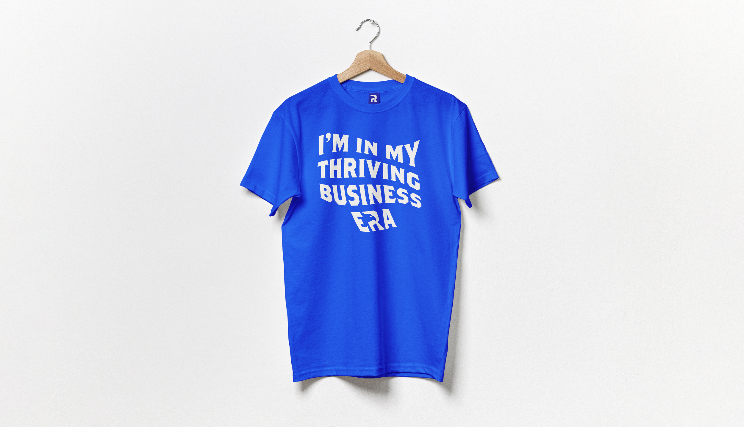 Royal blue Real Freedom t-shirt reading I'm in my thriving business era