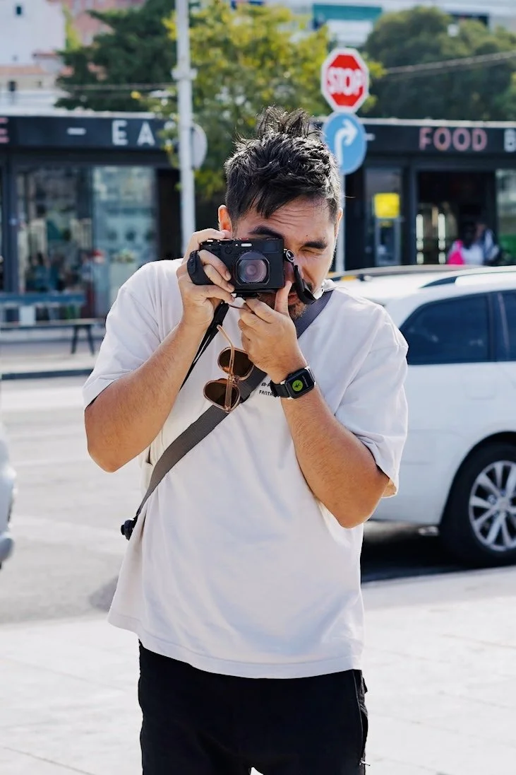A man taking a photo with his camera on a street in Split