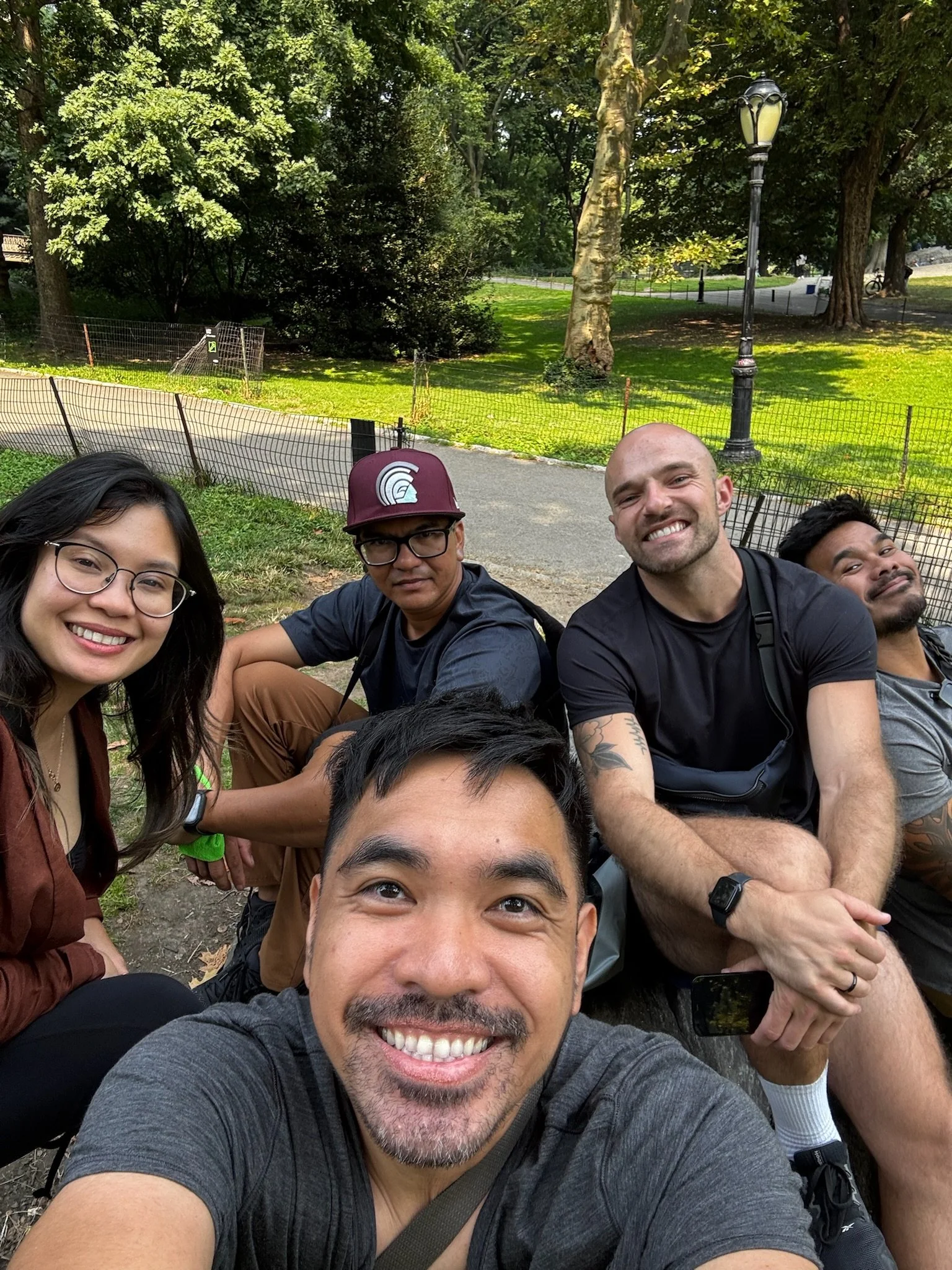 Group selfie of five friends taking a break in Central Park